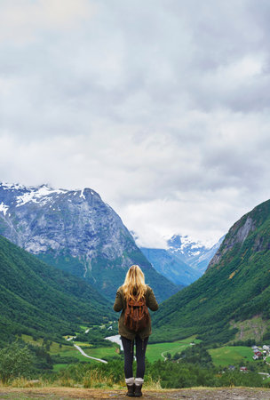 Travel adventure woman enjoying view of majestic glacial valley on exploration discover beautiful earthの写真素材