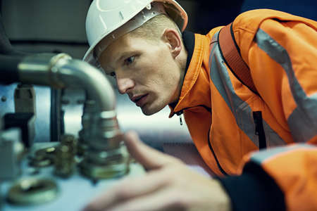 Solving little problems before they become big problems. Shot of a young engineer working with...