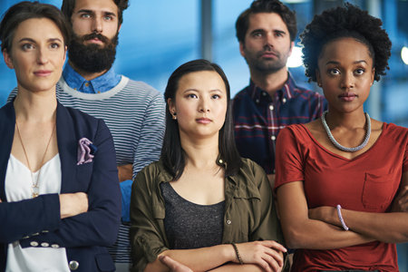 Were ready for anything. a group of creative businesspeople looking determined.の写真素材