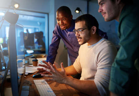 This is exciting stuff. a team of young businesspeople working late in the office.