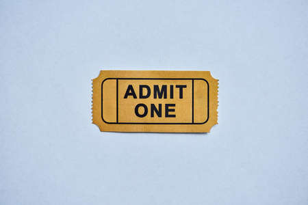 This is where the fun starts. a yellow movie ticket isolated on white.の写真素材