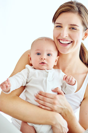 Im so proud to be his mom. Portrait of a loving mother carrying her baby boy at home.の写真素材