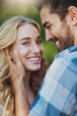 Hes making eyes at me. an affectionate young couple having a romantic moment outdoors.の写真素材