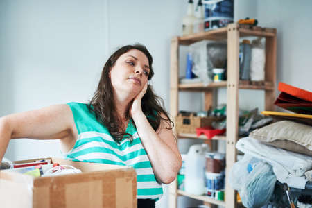 Shes tired of all the chores. a young woman overwhelmed from doing chores.