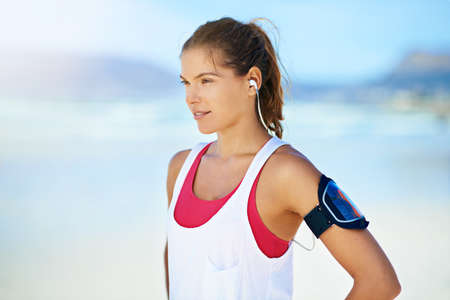 a young woman working out on the beach.