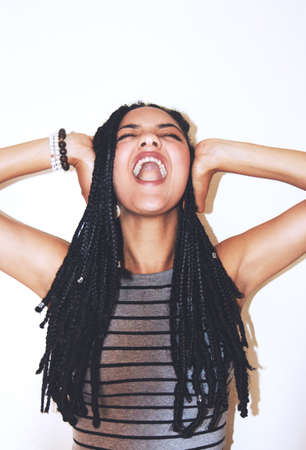 Studio shot of an attractive young woman covering her ears.