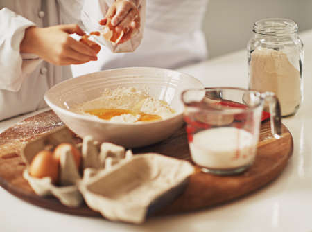 Lets get cracking. a mother and her son baking in the kitchen.の写真素材
