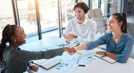 Business people, handshake and working together, deal or agreement in meeting. B2b, thank you and shaking hands in partnership, teamwork or collaboration together with client in corporate office.の写真素材