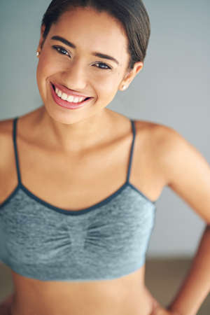 Your fitness is up to you. a sporty young woman posing against a grey background.の写真素材