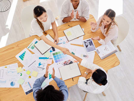 Handshake, collaboration and partnership agreement from sales business team working on innovation...
