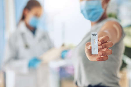Hand with pcr covid test at hospital, sick patient doing virus consultation with doctor at hospital and consulting with healthcare worker at clinic. Woman with professional corona exam resultsの写真素材