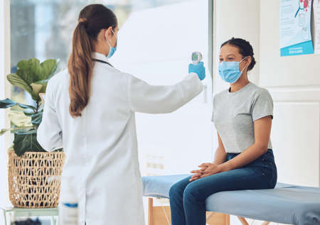 Healthcare, compliance and covid scan by doctor and patient with digital thermometer in a...