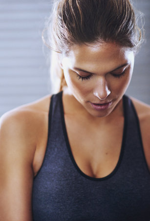 Getting psyched for her workout. a fit young woman at the gym.