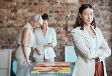Leadership, manager and portrait of business woman in a meeting for a art exhibition in a creative office. Confident team leader or boss with arms crossed and a goal for vision and mission successの写真素材