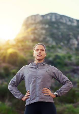 Theres always one more peak. a young woman out for a trail run.の写真素材