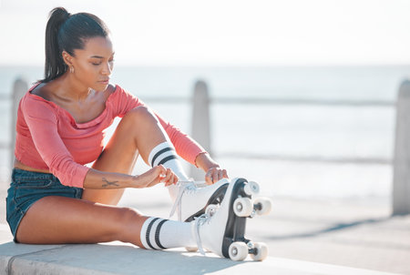 Fitness, exercise and happy woman roller skating along a beach on a sunny day, content while prepare...