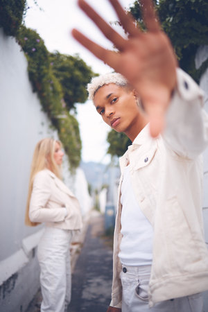 Fashion, model and gen z man from Guatemala in a alley outdoors pose for a luxury brand. Attractive,...