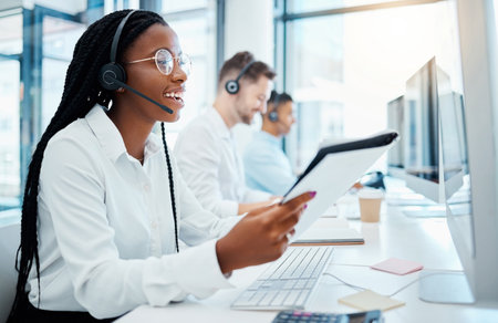Contact us, customer support and happy call center consultant working in office, smiling while helping clients. Young professional female enjoying provide good online or virtual service and adviceの写真素材