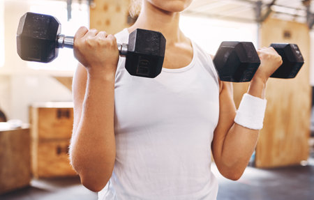 Hands of woman, dumbbell and exercise or workout at the gym for fitness and health. Healthy, sport...