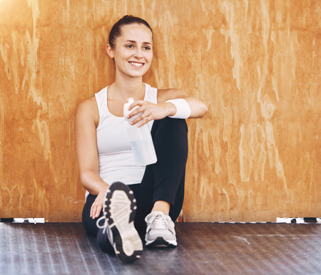 Fitness woman gym break, water bottle and healthy after workout, exercise and sports training in...