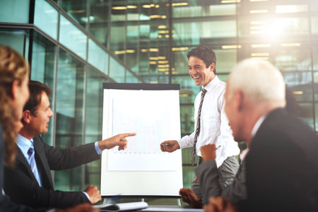 Great job. a group of businesspeople listening to a presentation.