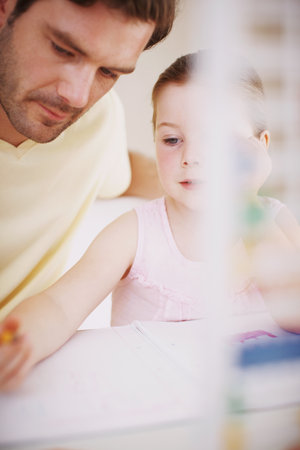 She always does her homework. a little girl doing her homework.の写真素材