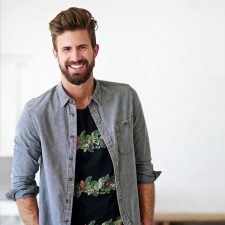 Doing business with a smile. Cropped portrait of a businessman standing in his office.の写真素材