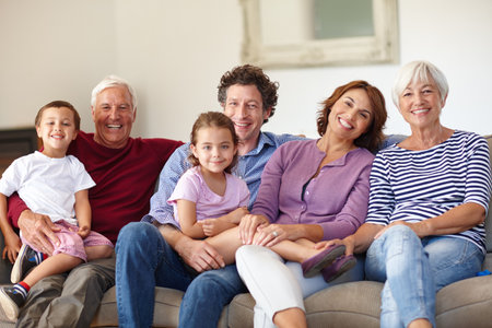 We love our family get-togethers. Portrait of a happy multi-generational family sitting together on...