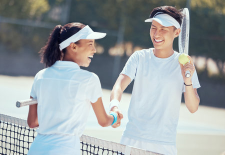 Tennis, handshake and teamwork with a health athlete or coach shaking hands on a sports court, game or match. Fitness, workout and training with friends saying thank you, well done or congratulationの写真素材