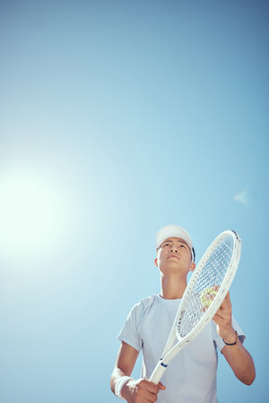 Tennis, training and serve with athlete playing on game court for sports, fitness and wellness. Motivation, workout and health lifestyle with young tennis player in outdoor competition matchの写真素材
