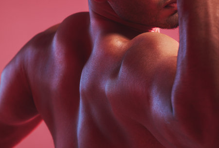 Sexy man, strong back and muscle bodybuilder in nude, fitness and skin against colorful studio...