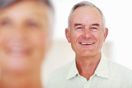 Handsome man smiling with woman. Focus on handsome mature man smiling with woman.