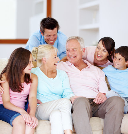 Laughter, love and affection. A loving family laughing on a lounge sofa together.