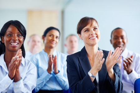 Colleagues applauding presentation. View of group of executives applauding.