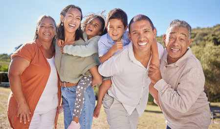 Summer vacation, big family and children in park or green nature garden on blue sky mockup. Happy portrait of mother, father and grandmother with grandpa and kids at an outdoor fun adventure togetherの写真素材