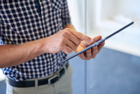 Digital marketing is the future. Cropped image of a man working on a digital tablet.