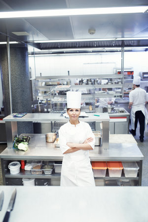 My kitchen is a well oiled machine. Portrait of a chef in a professional kitchen.の写真素材