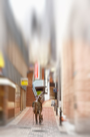 Motion blurred city life. Motion and lens blurred photo of city people.の写真素材