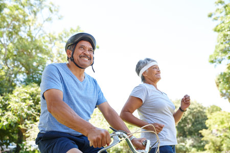 Fit for life. a happy senior couple going for a bike ride and a jog together outdoors.
