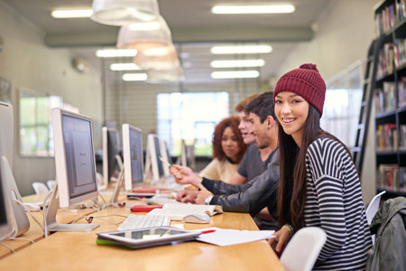 I love my study companions. students working on computers in a university library.
