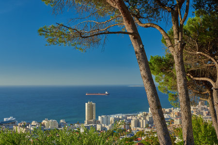 Take a vacation in paradise. a city on the coastline with mountains surrounding it.の写真素材