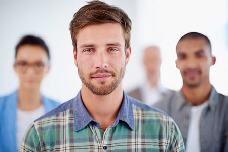 Were prepared to take on the serious issues. Serious looking young man with coworkers in the...