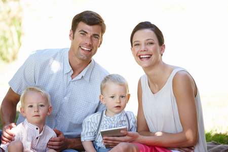 Updating status... family time. a happy family spending time together outdoors.