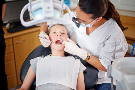 Taking a closer look. a female dentist and child in a dentist office.の写真素材