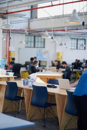 Its a creative environment. people working in a large office.の写真素材