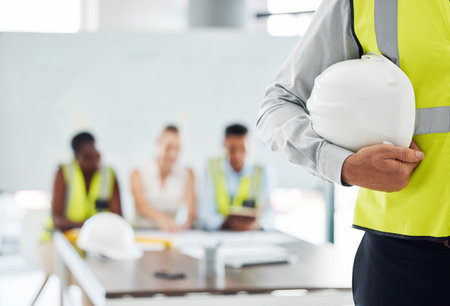 Man, building helmet and construction worker meeting with engineering leadership, manager and...