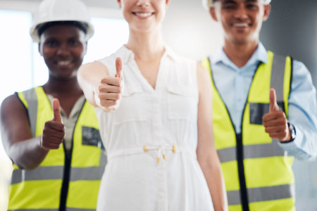 Thumbs up, hands or success for manager of construction worker, engineer or architect diversity. Collaboration, leader or trust gesture for building designer woman with teamwork or real estate visionの写真素材