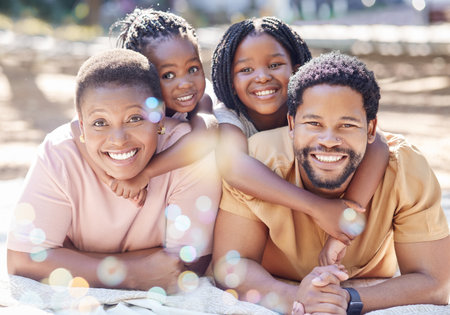 African family, happy portrait and park in summer, children in nature with parents and happy in garden during summer vacation. Face of girl kids with smile for mother and dad on holiday in springの写真素材