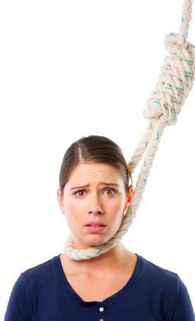 Hanging on by a thread. Studio shot of a young woman with a noose around her neck.の写真素材