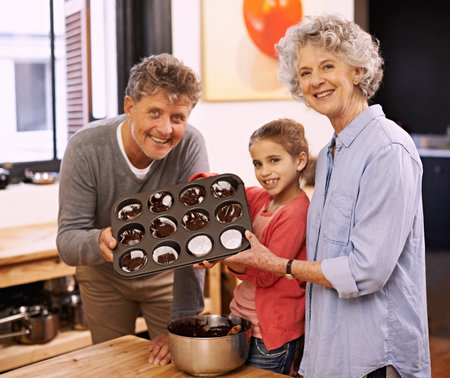 Look what weve made. A little girl cooking with her grandparents.
